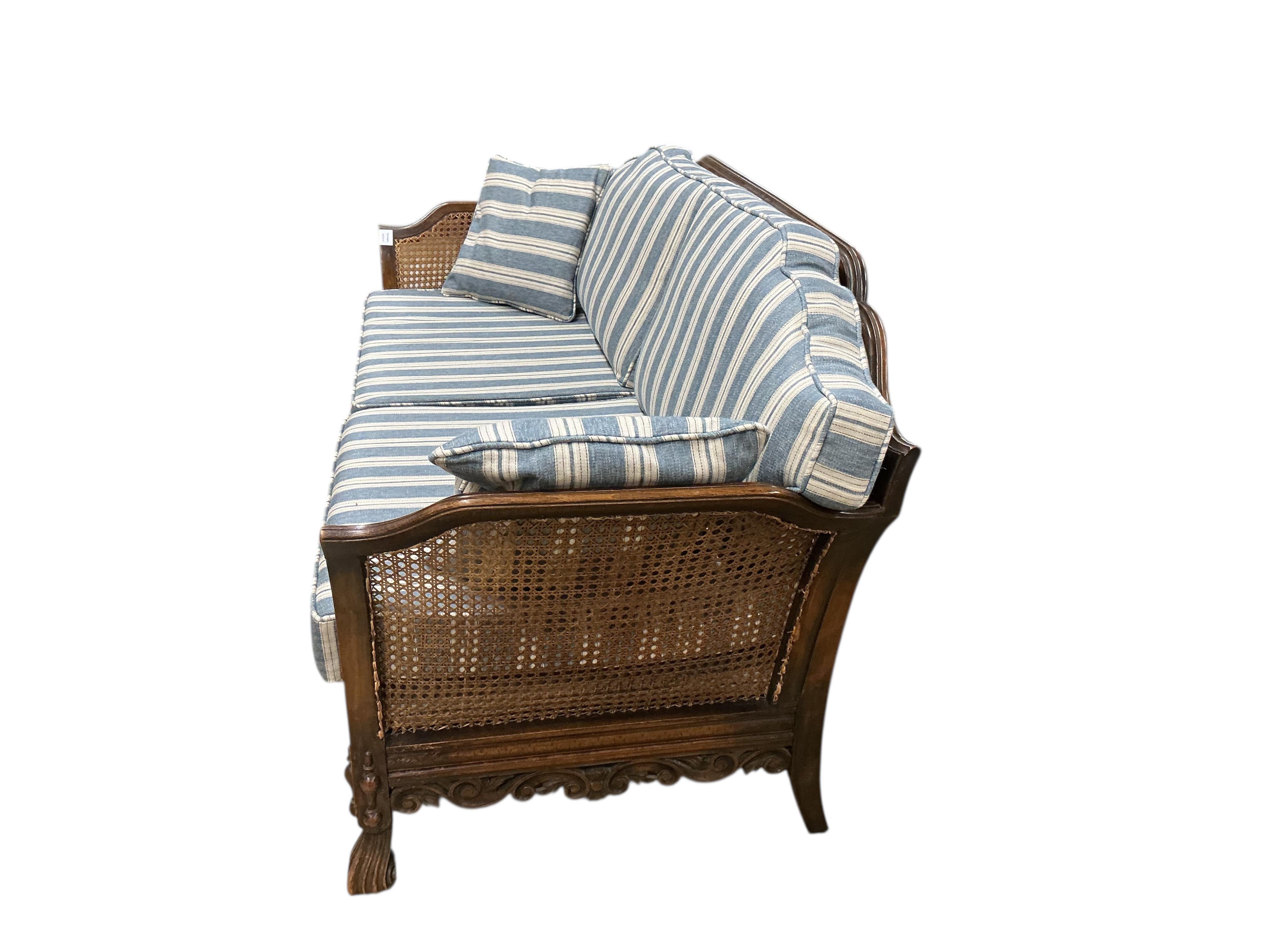 An early 20th century William & Mary style oak bergere settee, with loose cushion seat and back, width 172cm, depth 71cm, height 80cm